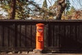 Red vintgae Japanese mail letter postbox and black wooden wall