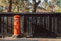 Red vintgae Japanese mail letter postbox and black wooden wall