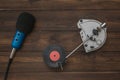 Red vinyl disc in vintage turntables and microphone on wooden background.