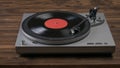 A red vinyl record player on a wooden table. Royalty Free Stock Photo