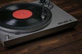 A red vinyl record player on a wooden table. Royalty Free Stock Photo