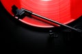 Red vinyl record spinning on a turntable - directly above