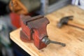 Red vise on work bench with hammer Royalty Free Stock Photo