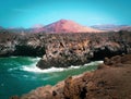 Red volcano close to wild sea cliffs Royalty Free Stock Photo