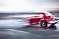 A red volkswagen beetle showing motion blur. Royalty Free Stock Photo