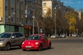 Red Volkswagen New Beetle car parked in a street of the city Royalty Free Stock Photo