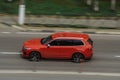 Red Volvo XC90 second generation on the city road. Fast moving car on Moscow streets. Vehicle driving along the street in city