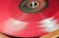 A Red Vynil Disc is being played in a player Royalty Free Stock Photo