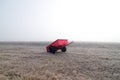 Red wagon and field in fog Royalty Free Stock Photo