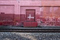Red wall along the train track in Portland, Oregon. December 2017
