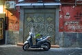 Evening illuminated Street Scene pf a parked scooter Naples