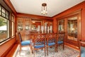 Red walls in dining room. Burgundy wooden table with carved chairs