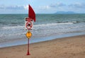Red warning flag on beach with Danger sign Royalty Free Stock Photo