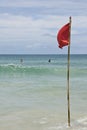 Red warning flag on beach water Royalty Free Stock Photo