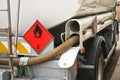 Red Warning hazmat Flammable class 3 liquid sign on back of fuel truck at petrol station Royalty Free Stock Photo