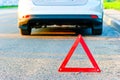 Red warning triangle and a car pull over to the side of the road Royalty Free Stock Photo