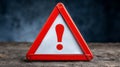 Red warning triangle with exclamation mark on a dark background Royalty Free Stock Photo