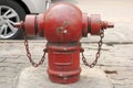 Red Fire Extinguisher is located on the street. Royalty Free Stock Photo