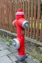 Red water hydrant in the middle of the footpath Royalty Free Stock Photo