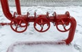 Red water tap on the street in winter in the snow. Water fire extinguishing system. Fire safety