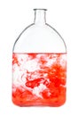 Red watercolour dissolves in water in bottle Royalty Free Stock Photo