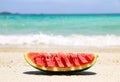 Red watermelon on a beautiful white beach