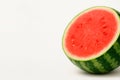Red watermelon, cut in half, on a light background. Space for text. Royalty Free Stock Photo