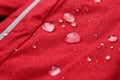 Red waterproof fabric with drops as background, closeup Royalty Free Stock Photo