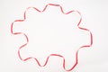 Red wavy ribbon in multiangle shape on white