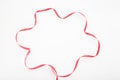 Red wavy ribbon in star shape on white