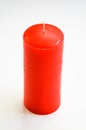 Red wax candle on a white background. Royalty Free Stock Photo