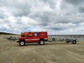 Red 4WD shore rescue service Landrover car on a shore