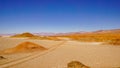 Road across salt flats in the high altitude desert of Salta`s puna region in Argentina Royalty Free Stock Photo