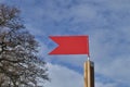 Red weather vane against blue sky Royalty Free Stock Photo