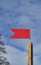 Red weather vane against blue sky