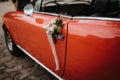 a red wedding car with flowers on the door handles Royalty Free Stock Photo