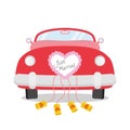 Red wedding car seen from behind with heart decoration and Just Married written on it