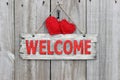 Red welcome sign hanging on wood door with red hearts and iron keys Royalty Free Stock Photo