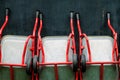 Red wheelbarrows against dark wall background