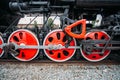 Red wheels of old black steam locomotive, close up Royalty Free Stock Photo