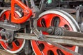 Red wheels of old steam locomotive with drive mechanisms Royalty Free Stock Photo