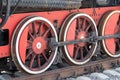 Red wheels of a vintage steam train locomotive close up, detail of a train of great world war times Royalty Free Stock Photo