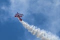 Red and White Airplane in the blue sky doing stunts Royalty Free Stock Photo