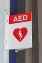 Red and white Automated External Defibrillator AED sign in a public place Royalty Free Stock Photo