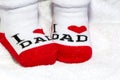 Red and white Baby socks on white blanket showing love to mother text Royalty Free Stock Photo