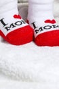 Red and white Baby socks on white blanket Royalty Free Stock Photo