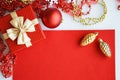 Red and white background for decoration for Christmas and New Year. A wish card, a gift box with a golden bow, a red Christmas bal Royalty Free Stock Photo