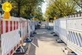 Red and white barricades with warning lights on a street in a re