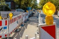 Red and white barricades with warning lights on a street in a re