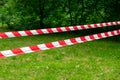 Red and white barrier line on the road in the park